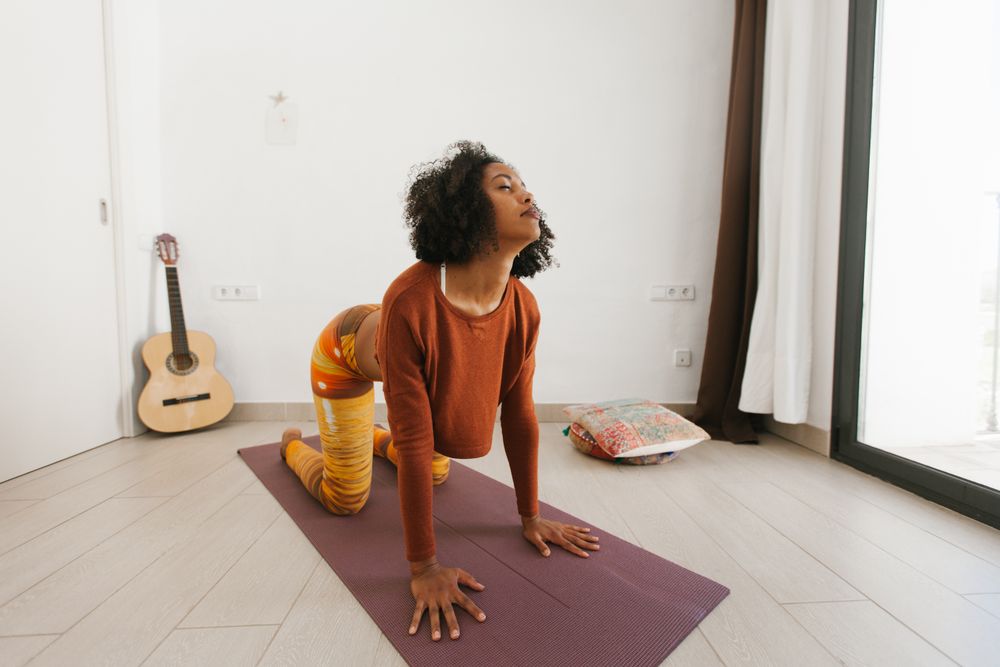 Sportive woman sitting in yoga pose with closed eyes