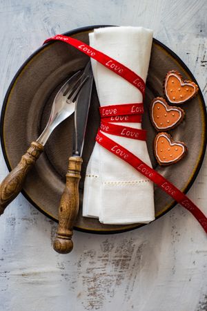 Red ribbon wrapped napkin for Valentine's Day table setting