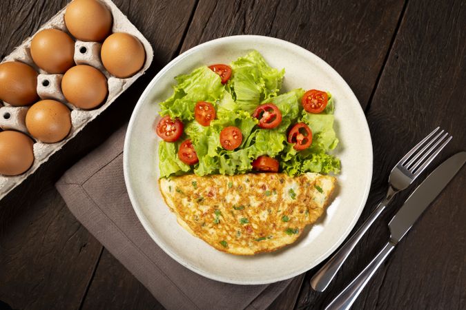 Omelet with cheese and lettuce and tomato salad.