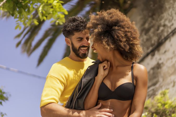 Happy couple flirting on street