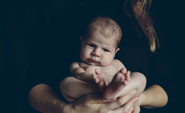 Baby posing in her mother's arms