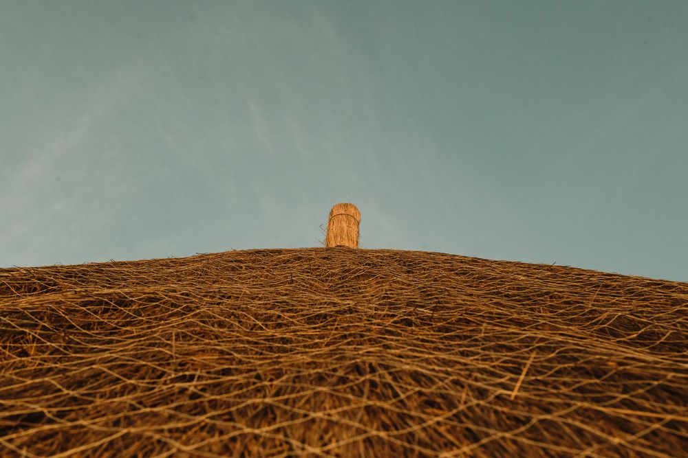 Thatched roof against blue sky