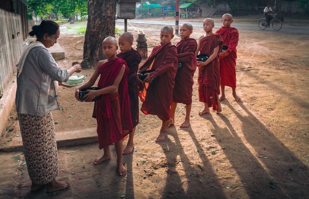Mandalay, Myanmar - June, 25 2012: Monk boys standing in queue for food