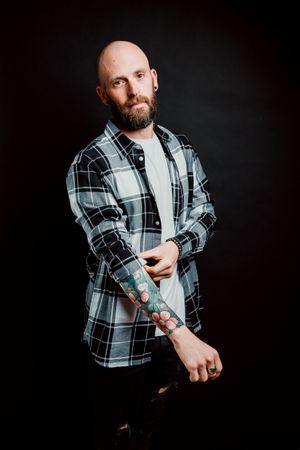 Young bald guy showing tattoos