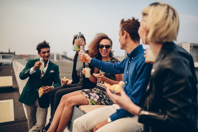 Young men and women having drinks on rooftop