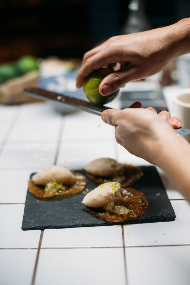Man grating lime zest onto desert