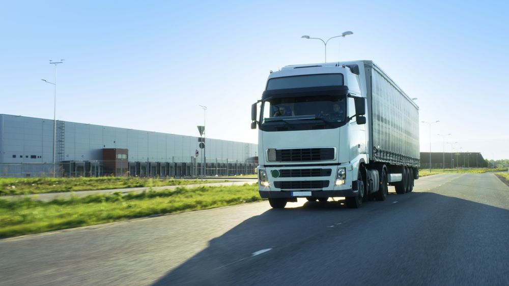 Front-View of Semi Truck with Cargo Trailer Driving on a Highway.