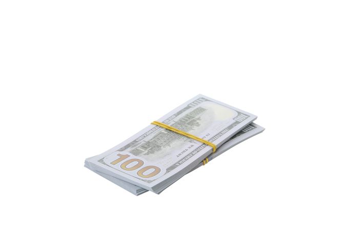 Stacks of American cash money, isolated on light background