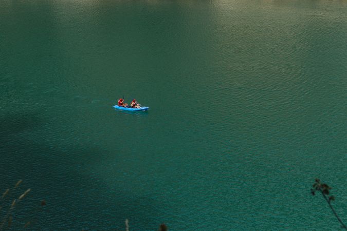 People crossing a river by kayak