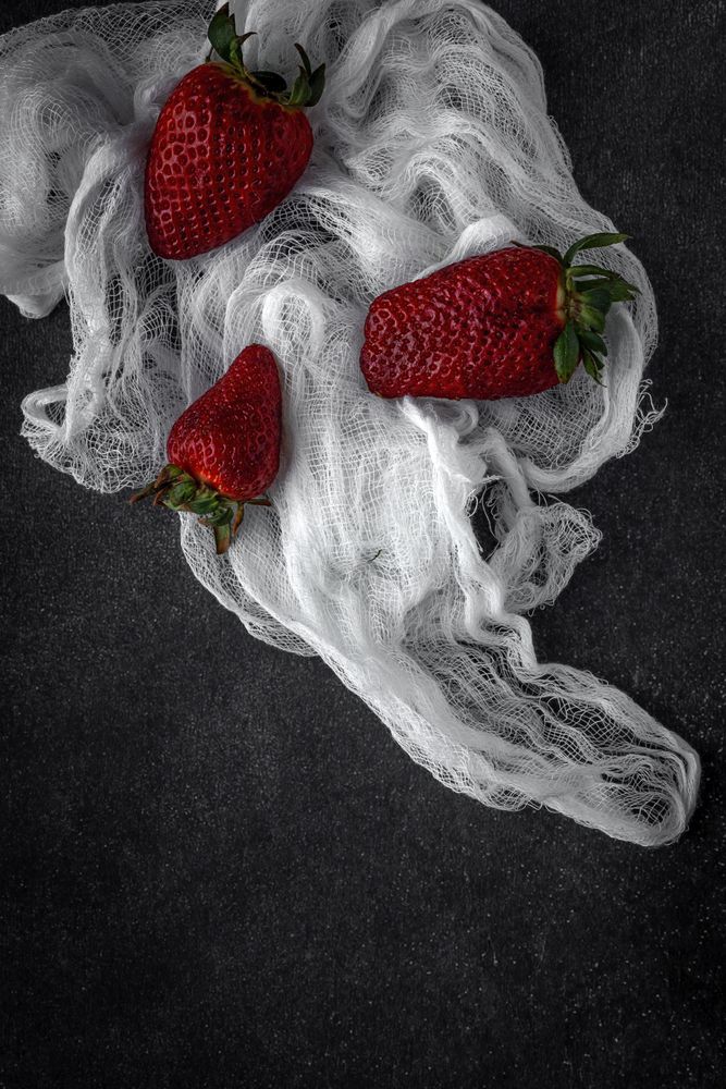 Red and fresh strawberries flat lay in a piece of cloth