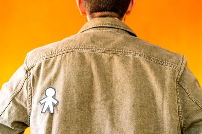 man with funny paper toy on jean jacket