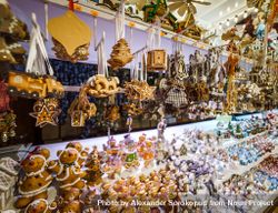 Traditional Christmas market with handmade souvenirs on shelves in shop 0yRJ15