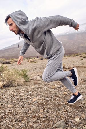 Focused man running in mountains