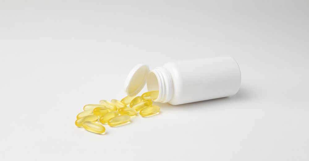 Mockup of a bottle of omega 3 capsules, food supplement, lying down with copyspace