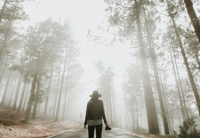 Woman with camera in forest