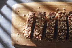 Sliced wholegrain bread on wooden cutting board