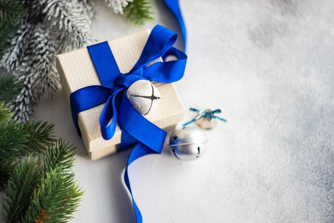 Christmas present with blue ribbon and bells with space for text