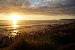 sandy and rocky beach and the ocean in sunset lights in canary island