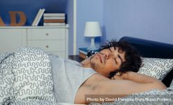 Man sleeping comfortably in bed at home 4mWRGz