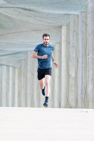 Sportsman jogging outdoors under cover