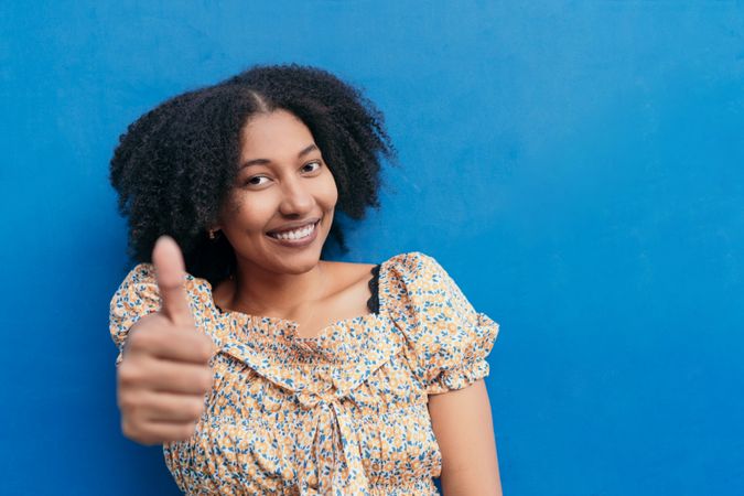 Young woman on a blue background on a summer's day