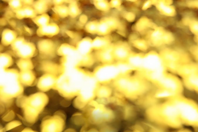 Blurred golden glitter on whole background, close up
