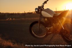 Classic motorbike parked on the road during sunset 5Rq1A0