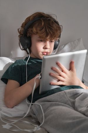 Focused boy watching video on tablet