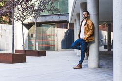Stylish man outside modern building