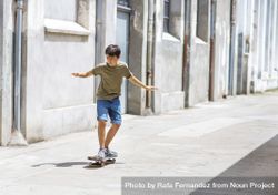 Front view of teenage boy skateboarding on street on a sunny day 4MGovk