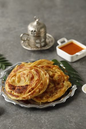 Roti Parata or Roti Canai with Lamb Curry Sauce, Yoghurt and Turkish Tea