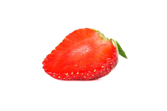 Half of strawberry isolated on light background. Summer sweet fruits and berries