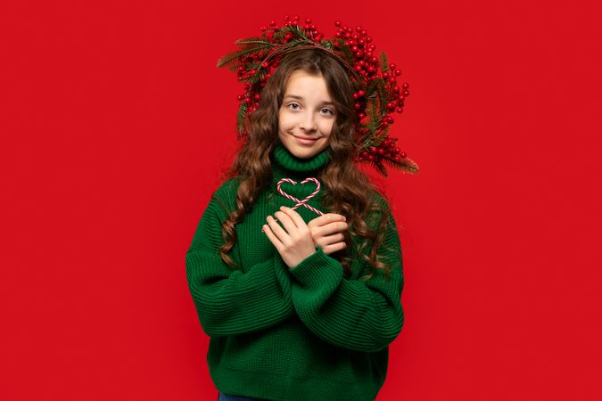 Young girl holding candy canes in heart shape