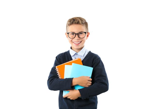 Boy with glasses and copybooks isolated on blank background