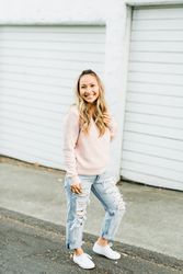 Smiling woman standing beside garage door