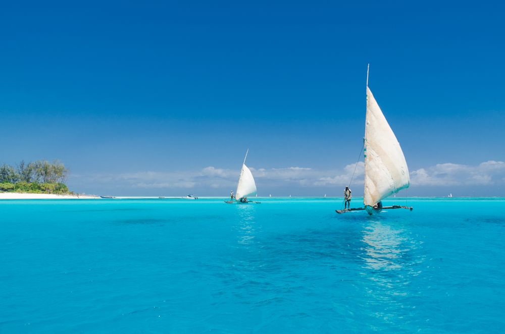 People sailing on a clear day, on clear water