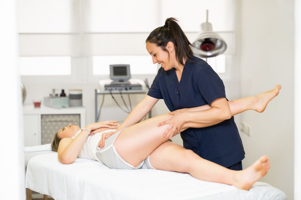 Female medical professional working on her patient’s leg