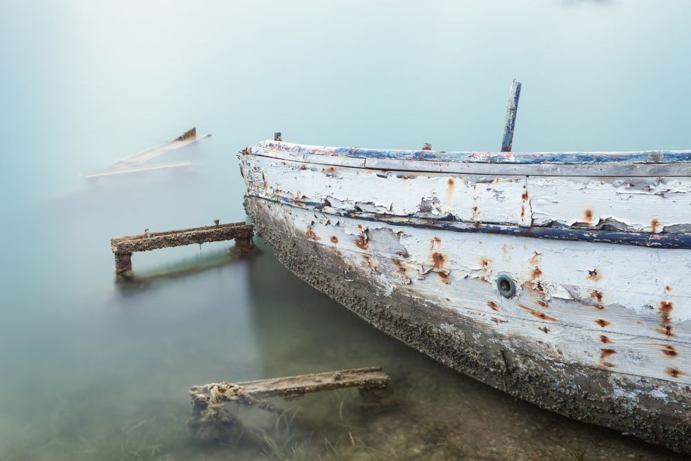 Old rusty boat in misty water