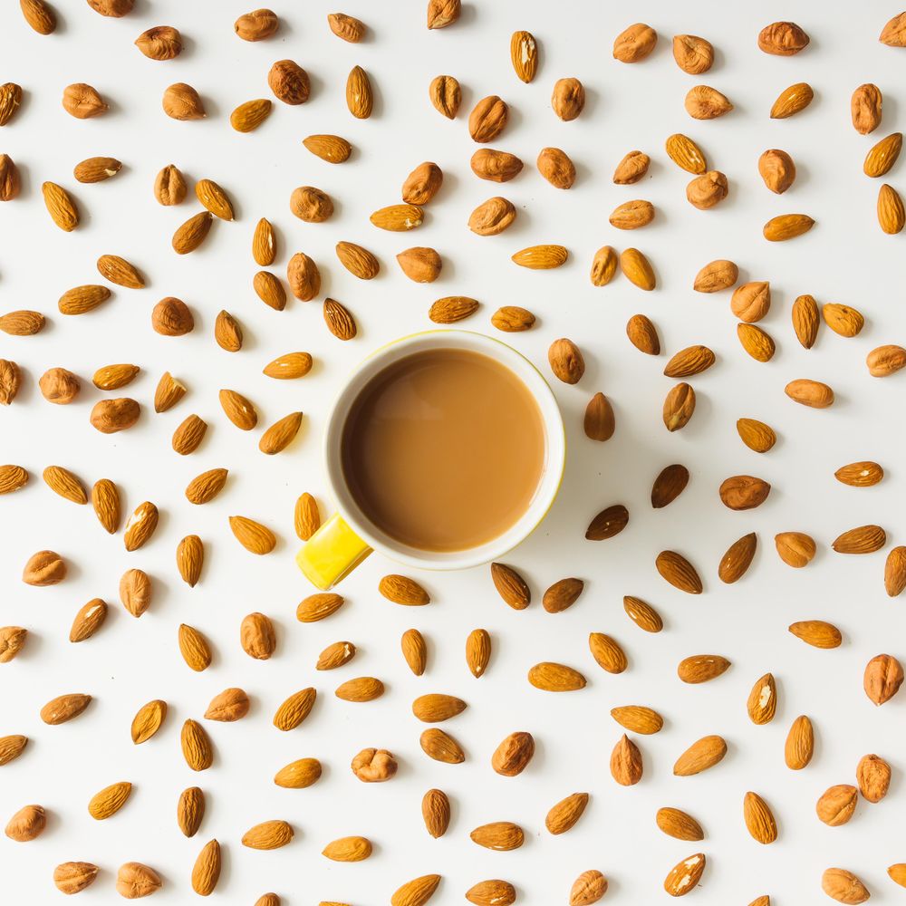 Pattern made of almonds with coffee cup