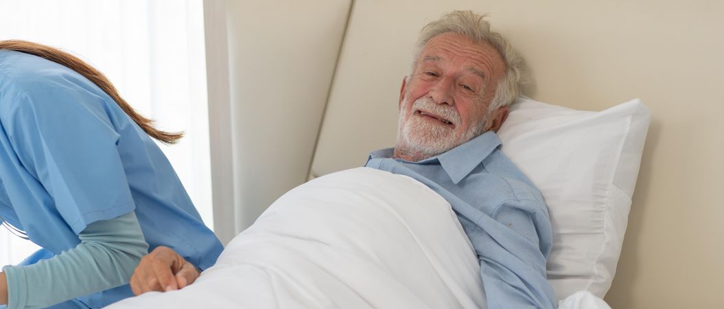 Happy mature man resting and recovery on bed