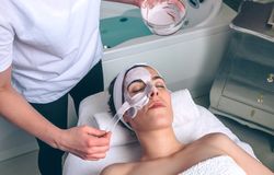 Female resting with eyes closed while having a clay mask applied