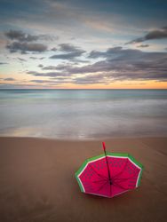 Umbrella on beach near sea