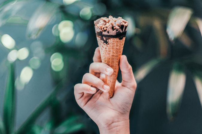 Person’s hand holding ice cream cone