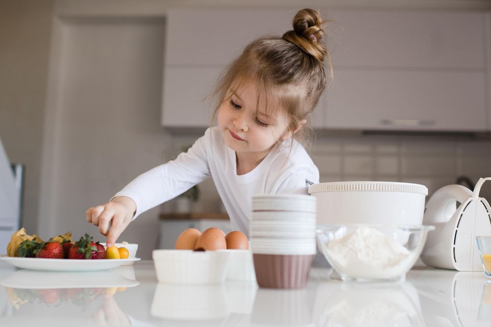 Young girl leaning on kitchen counter