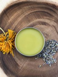 Pot of cannabis salve with lavender and a flower