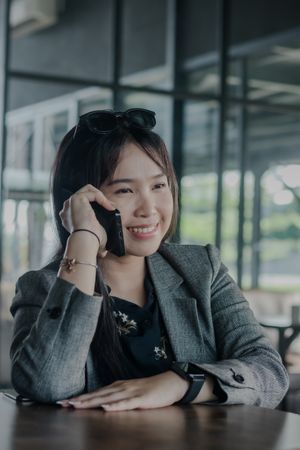 Focused young businesswoman engaged in a phone conversation indo