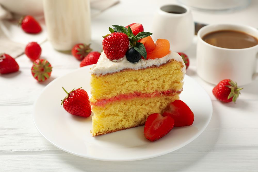 Composition with delicious berry cream cake on wooden table. Tasty dessert