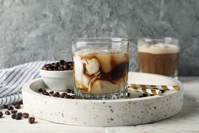 Composition with tray with ice coffee on wooden background