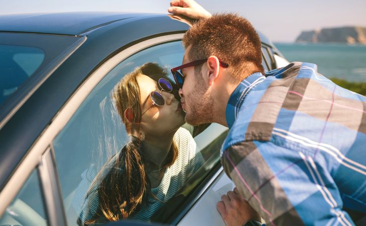 Young couple kissing through the glass