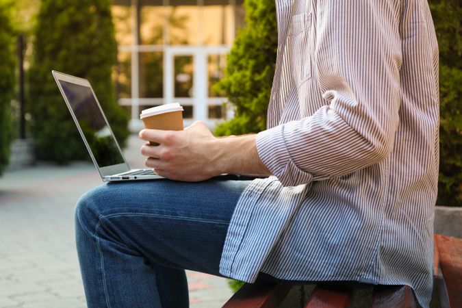 Young student working in a laptop and drinking coffee. Study. University
